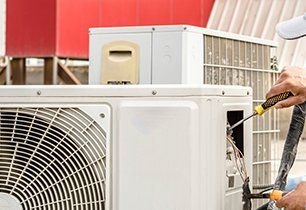 Technician servicing a ductless mini-split system